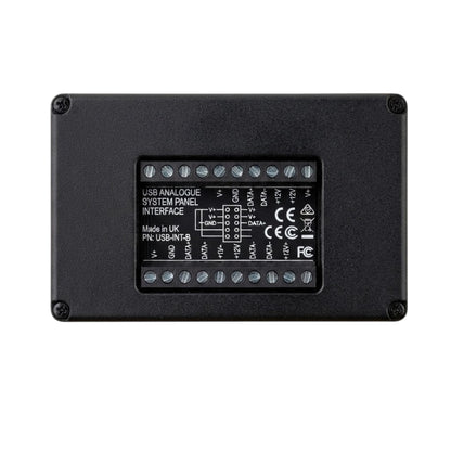 A black metal electronic module showing the back side with screw terminals and printed technical specifications for a USB analogue system panel interface.