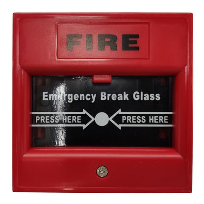 A red fire alarm emergency break glass release button with 'FIRE' printed in black at the top and 'Emergency Break Glass' with directional arrows and 'PRESS HERE' text on the glass.