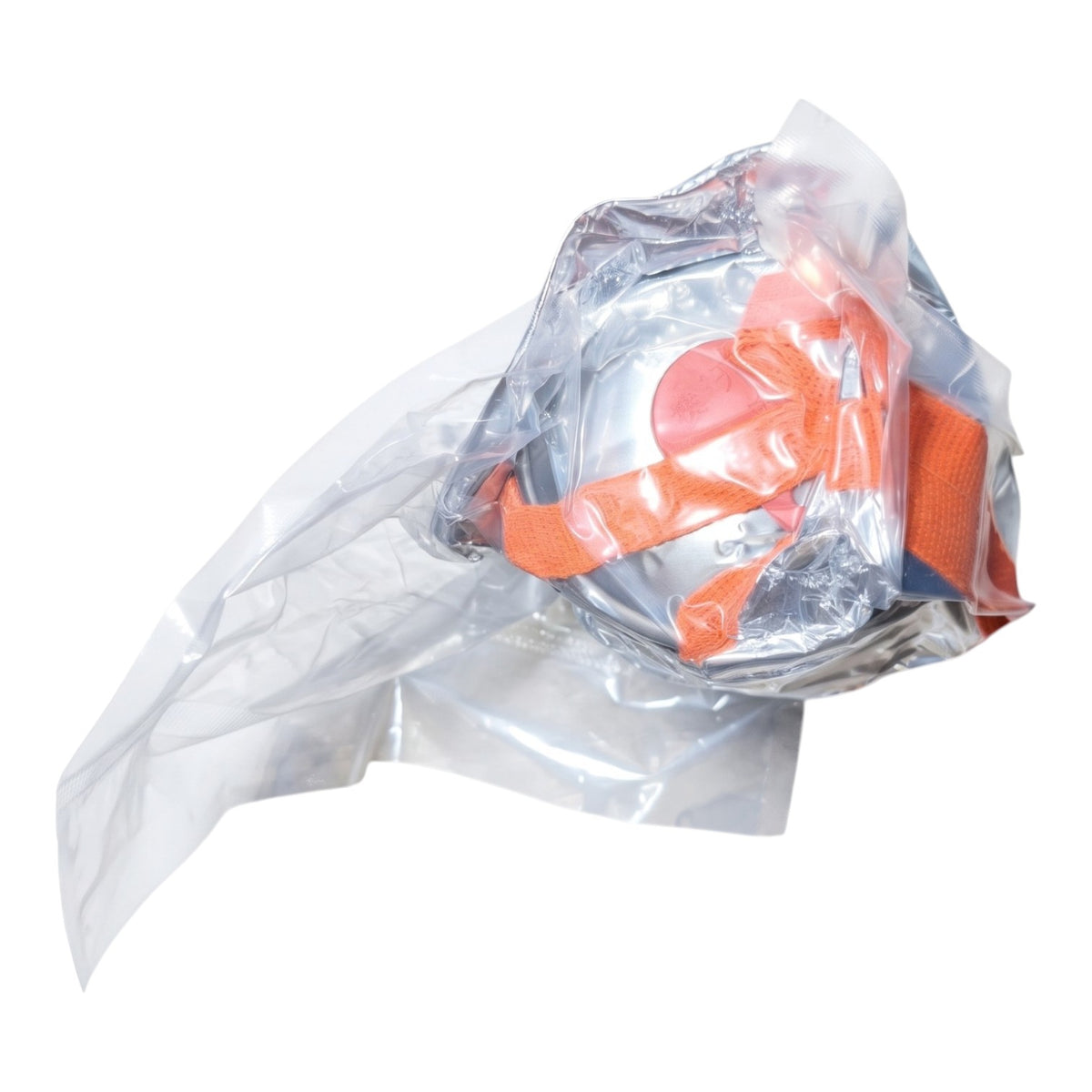 A clear plastic face mask with bright orange straps, sealed inside a crinkled transparent plastic bag, shown on a plain white background.