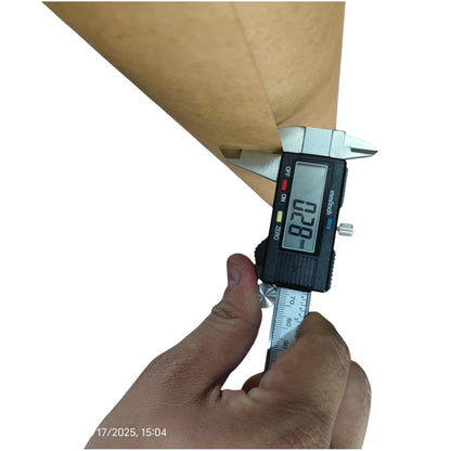 A hand holding a silver digital caliper against a brown paper cone to measure its diameter, with a white background and a small timestamp in the lower-left corner.