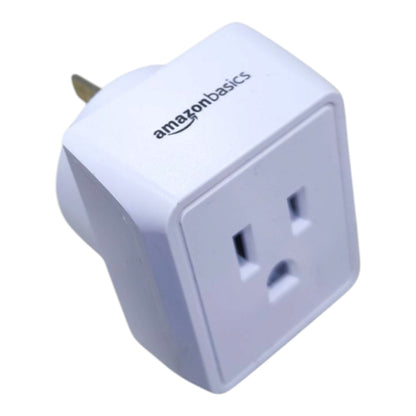 White Amazon Basics brand US to UK wall plug adapter with a gold-tone pin, shown on a plain white background.