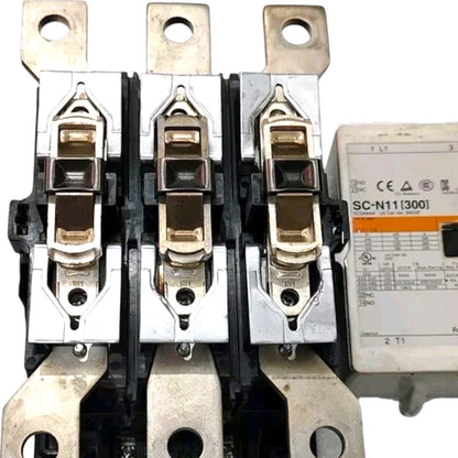 Three-phase electrical contactor with a white differential relay unit, showing metal contacts, terminal blocks, and technical specifications printed on the relay.