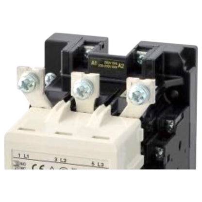 A close-up of an electrical contactor or relay component with a cream-colored lower housing, black upper mechanism, and silver terminal screws on a white background.