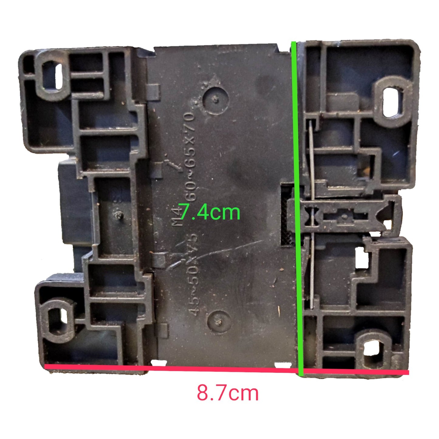 Black plastic component with measurements marked on a white background