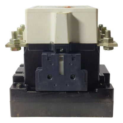 Electrical contactor with black base and beige top on a white background