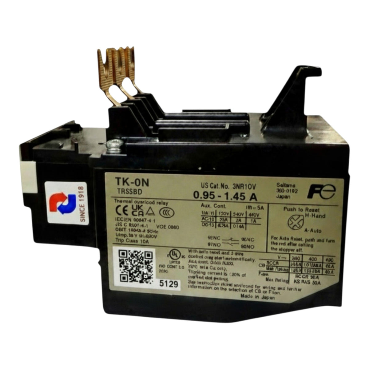 A black electrical fuse holder with a silver label showing technical specifications, featuring two gold-colored metal contact pins on top and a white brand sticker on the side.