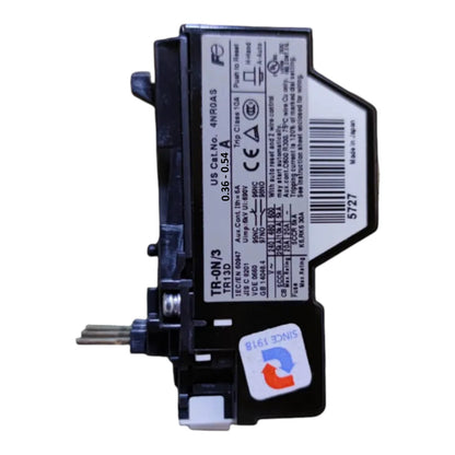 A black electrical contactor or relay component with a white technical specification label, photographed on a plain white background.