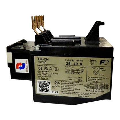 A black electrical fuse holder with a silver label showing technical specifications, featuring two gold-colored metal contact pins on top and a white brand sticker on the side.