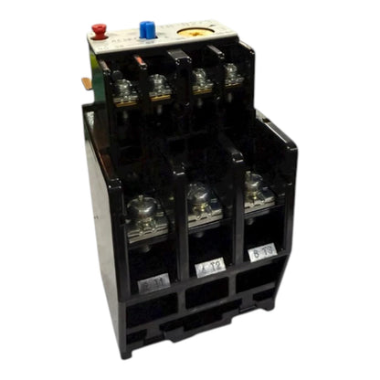A black electrical contactor or relay component with multiple terminal connections, a white top plate, and small colored buttons or knobs, shown on a plain white background.