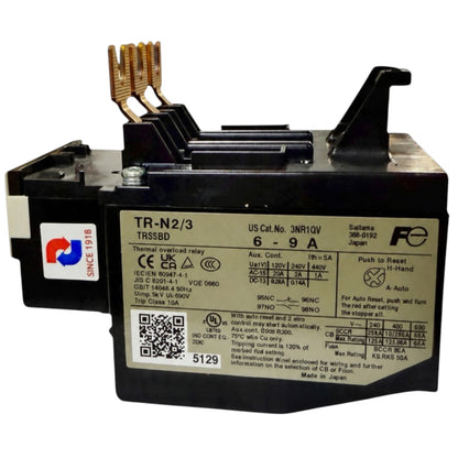 A black electrical contactor relay with copper-colored terminal posts, a white product label with technical specifications, and a red and blue sticker on the side, photographed on a white background.