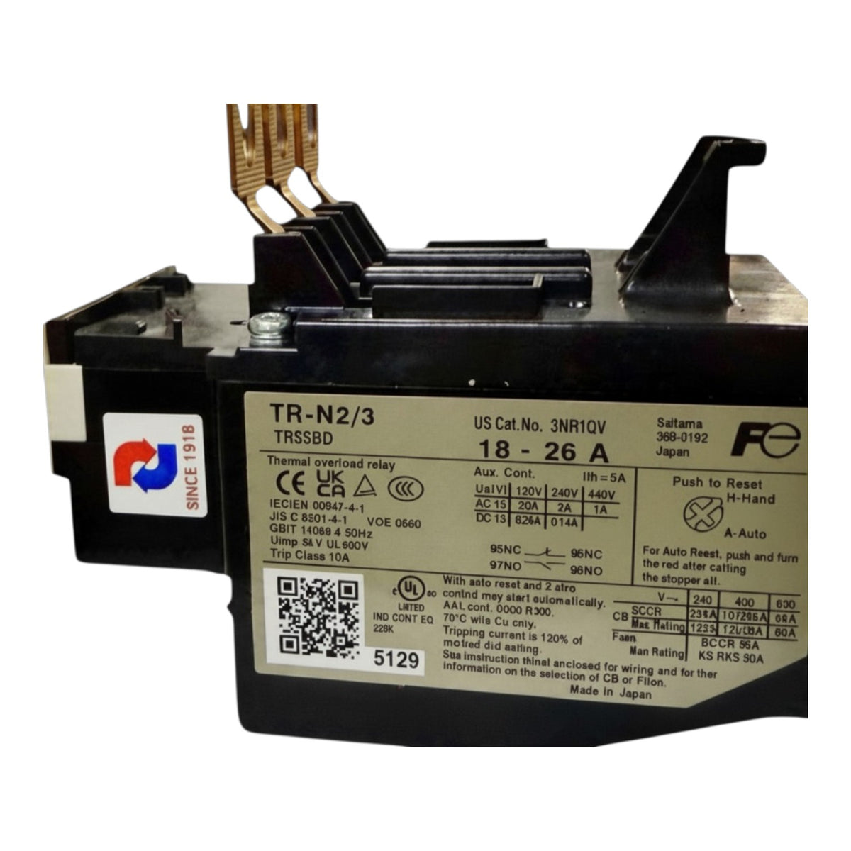 A black and silver TSUBDD TR-N2/3 thermal relay with a white technical specification label, featuring gold-colored terminal leads and a reset button on top.