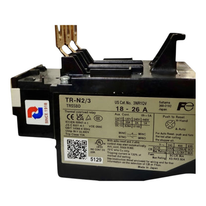 A black and silver TSUBDD TR-N2/3 thermal relay with a white technical specification label, featuring gold-colored terminal leads and a reset button on top.