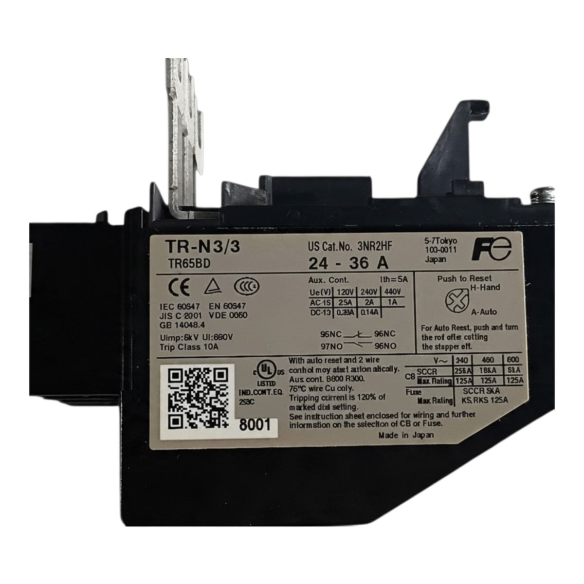 A black industrial electrical contactor relay with a large white specification label, featuring a vertical metal terminal post on the left and a push-button reset on the top right, photographed on a white background.