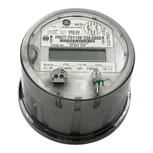 A GE 3-phase industrial digital watt-hour meter, model PBZT-701159, featuring a gray metal casing, a clear protective top cover, and an LCD display window.