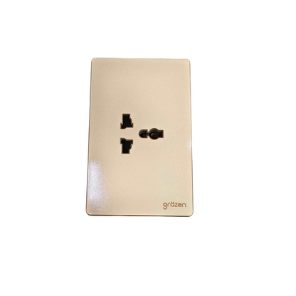 A single wall outlet cover plate in a warm champagne-gold finish, featuring black electrical sockets and the 'grézen' brand name printed in gold near the bottom right, set against a plain white background.