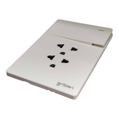 A white plastic multi-socket wall outlet with four UK three-pin plugs and a small green LED indicator light, branded 'grözen' on the front, shown on a plain white background.