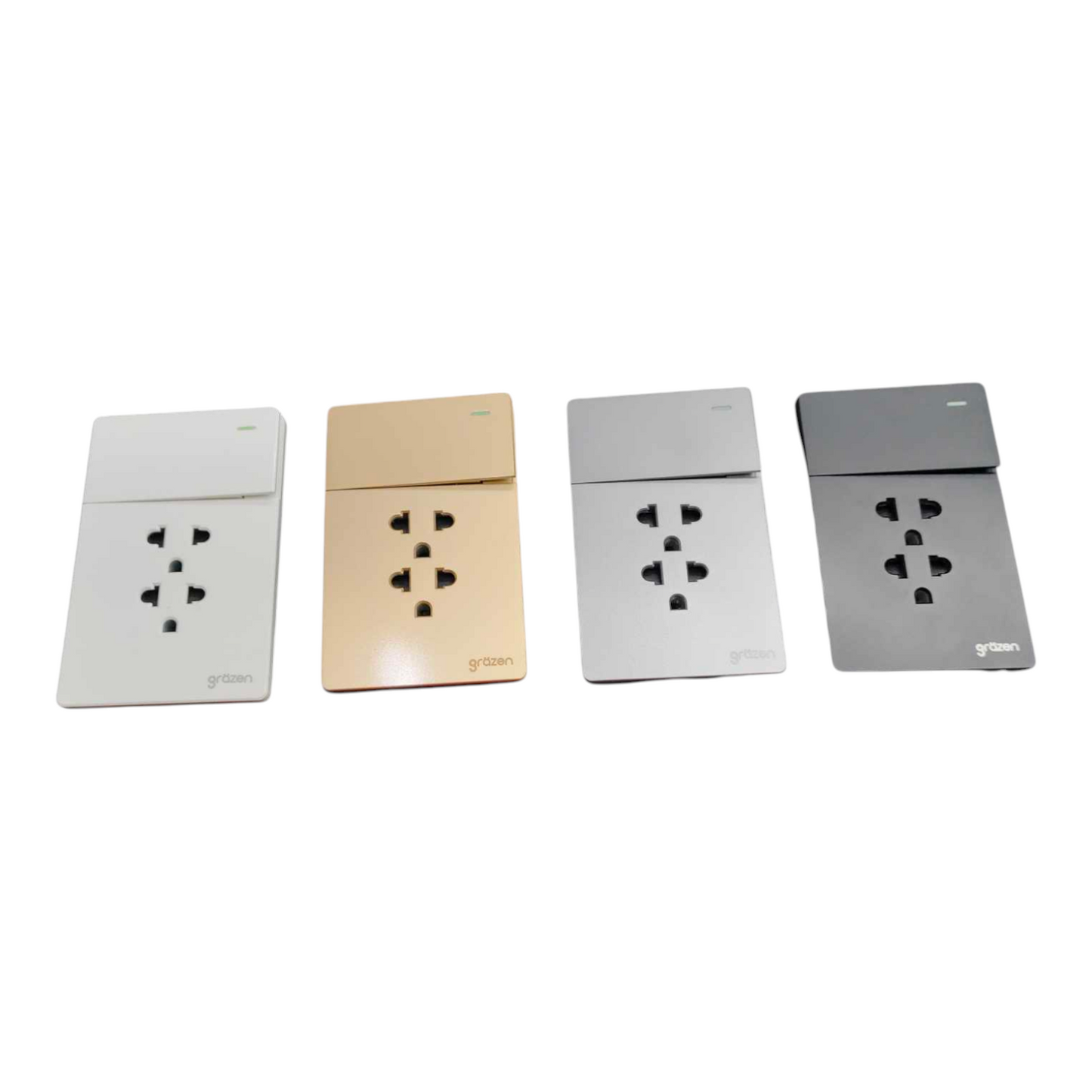 Four modern wall outlet sockets in different finishes (white, champagne gold, silver, and dark gray) arranged in a row on a plain white background.