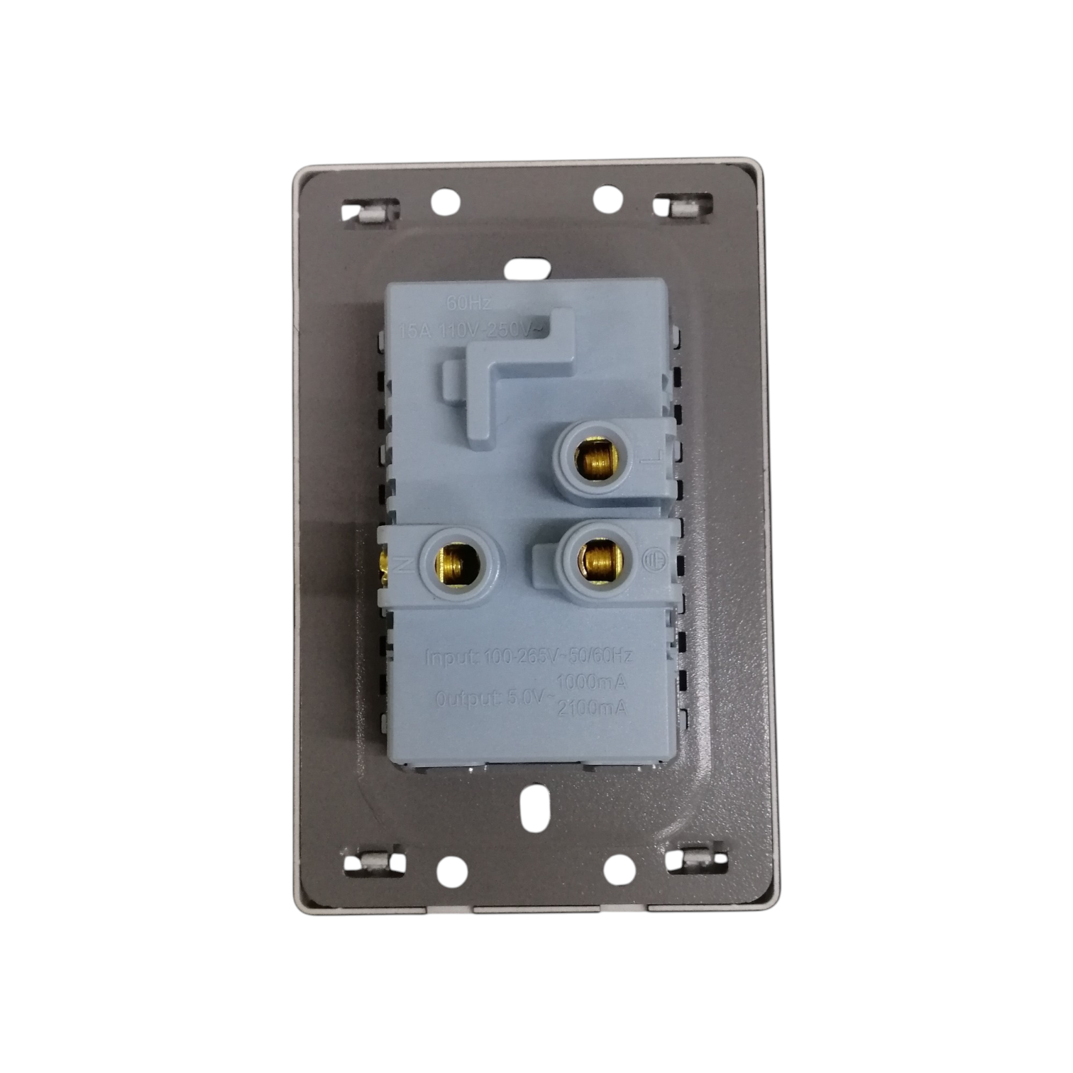 A rear view of a gray electrical wall switch plate showing the internal terminal block with gold screw contacts, isolated on a white background.