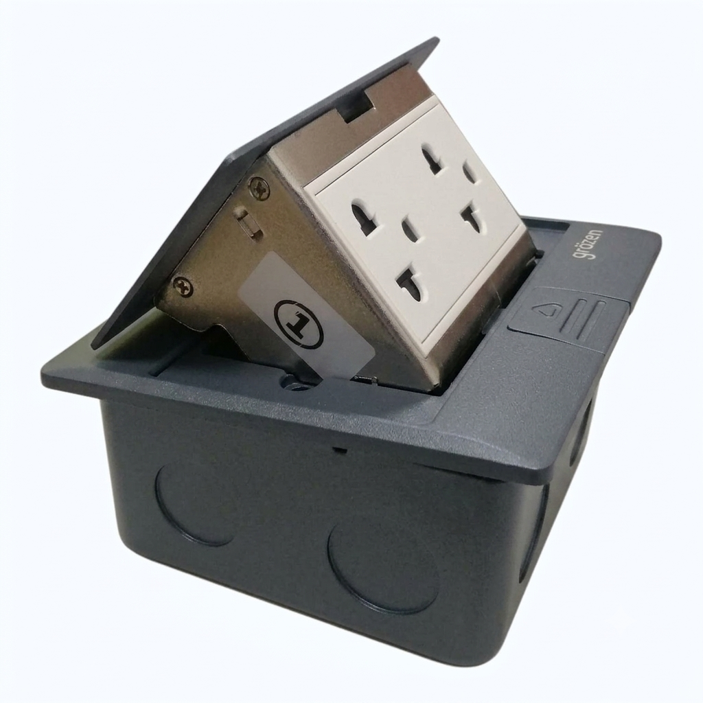 A dark gray electrical outlet cover with an angled stainless steel and white three-pin socket, shown on a plain light gray background.