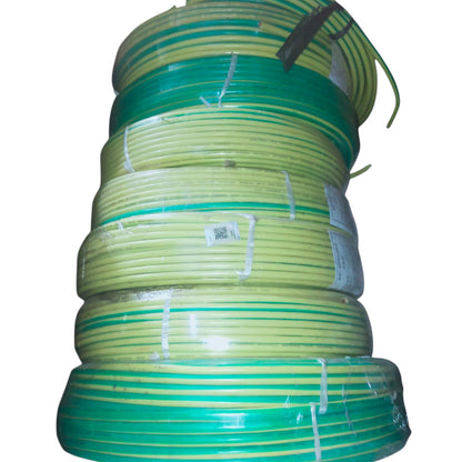 A stack of coiled green and yellow electrical wire or cable rolls wrapped in clear plastic, isolated on a white background.