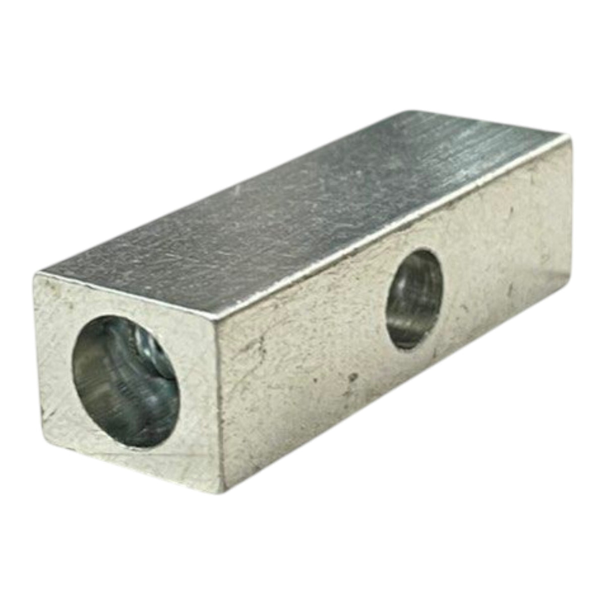 Metal block with two cylindrical holes on a white background