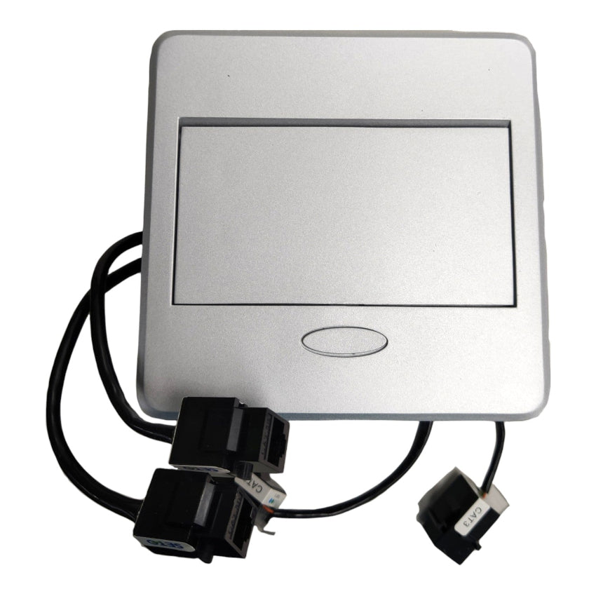 A square silver electronic control panel or switch module with a recessed rectangular area on the front, a small oval button below it, and attached black cables ending in connector plugs, shown on a plain white background.