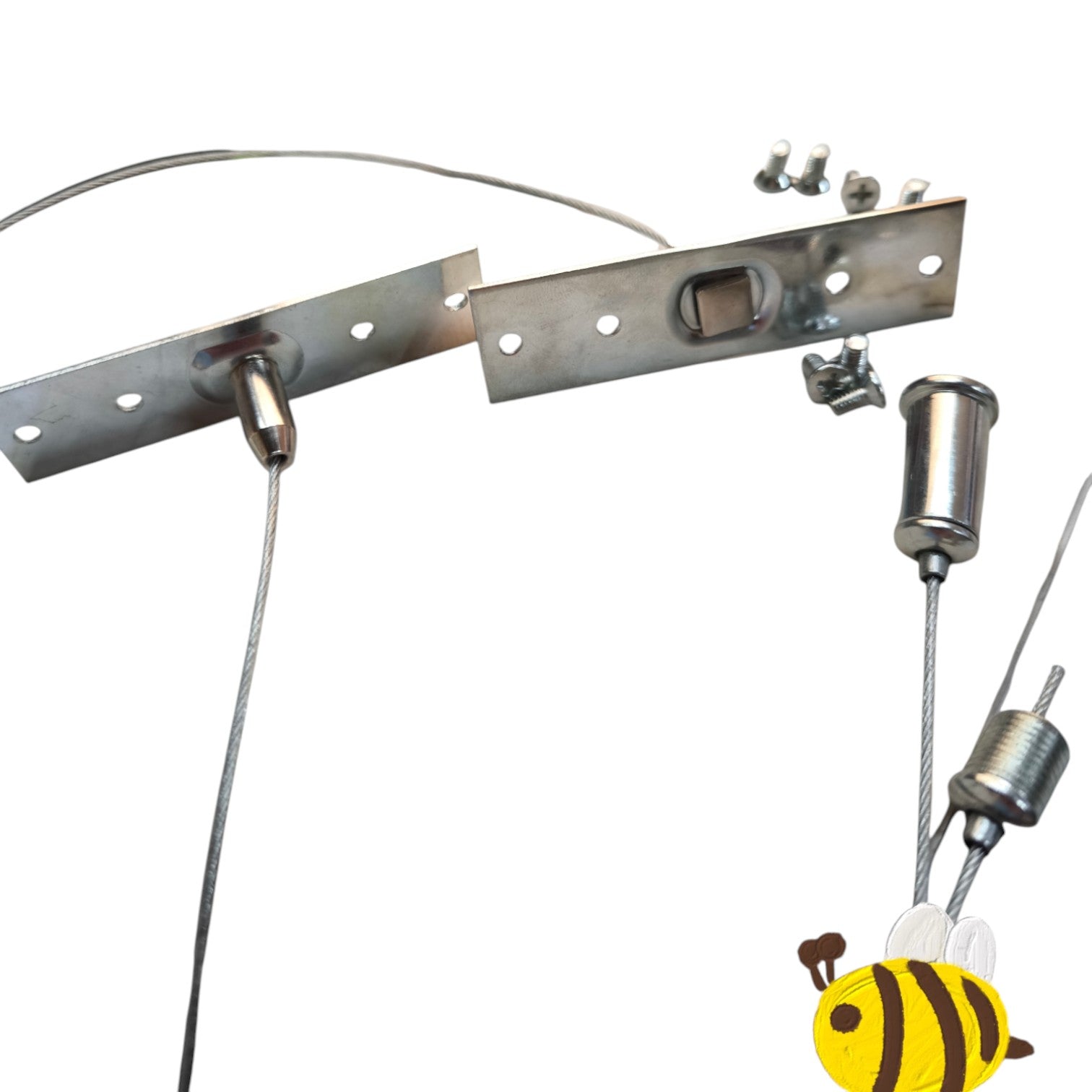 A stainless steel cable lock and latch hardware kit with mounting brackets, bolts, and cable ends, shown on a plain white background with a small bee graphic in the lower right corner.