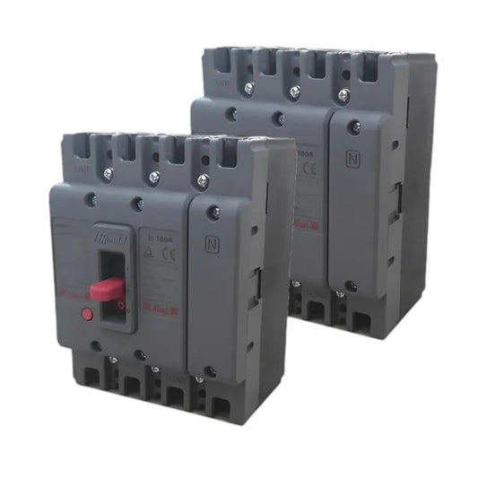Two gray industrial circuit breakers shown on a plain white background, with one in front and one behind. The front breaker has a red switch handle and printed specifications on its side.