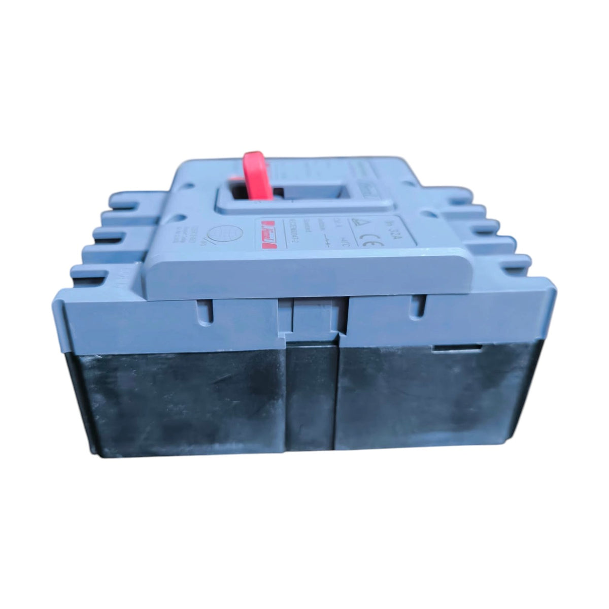 A gray plastic electrical component or fuse holder with a red switch handle on top, shown against a plain white background.