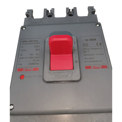 A close-up of a Hinkley electrical circuit breaker, model HMK3-400F3XXX, featuring a large red manual trip switch on a gray plastic housing with technical specifications printed on both sides.