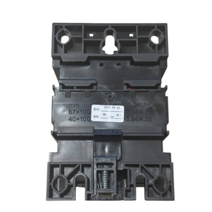 A black plastic electrical contactor or relay component with printed specifications and a white label sticker, isolated on a white background.