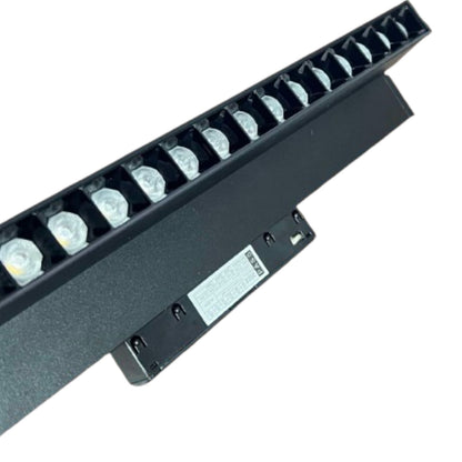 A black linear LED light bar with multiple clear lenses and a mounting bracket, shown on a plain white background.