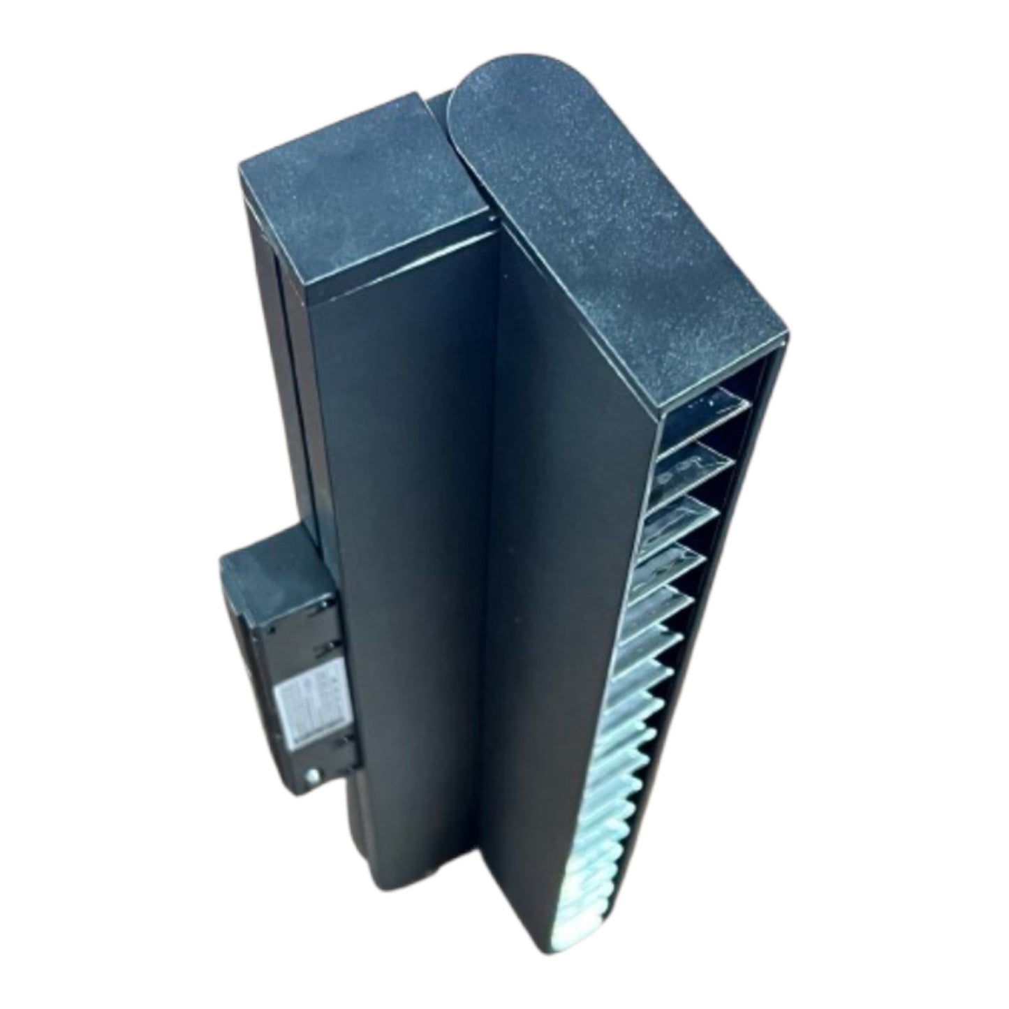 A black metal industrial component or enclosure with a ribbed side panel and a small attached box, shown on a plain white background.