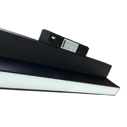 A close-up of a black LED under-shelf light bar with its power adapter attached, shown against a plain white background.