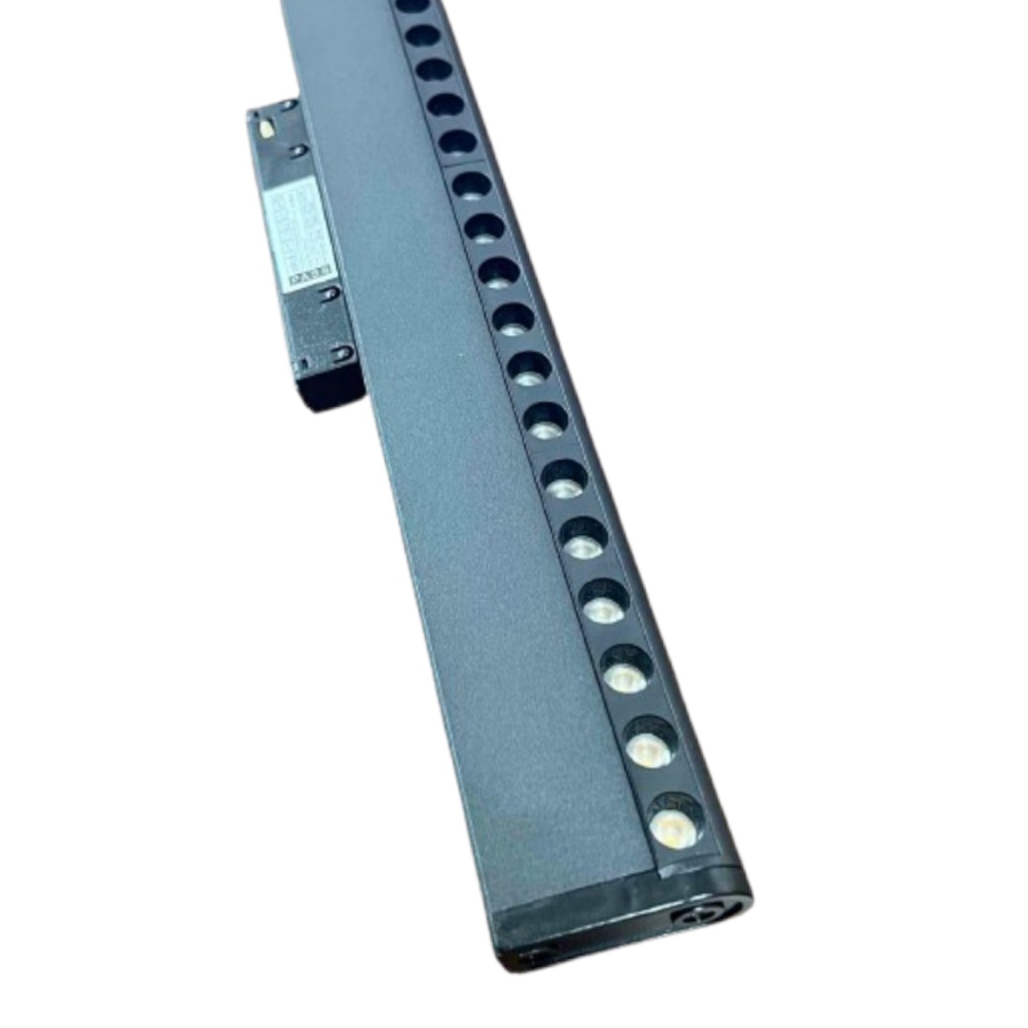 A long, dark gray metal mounting rail with a series of circular cutouts along one side and a small attached bracket with a white label, shown on a plain white background.
