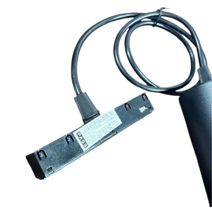 A black industrial electronic sensor module with a coiled black cable and a cylindrical black probe, shown on a plain white background.