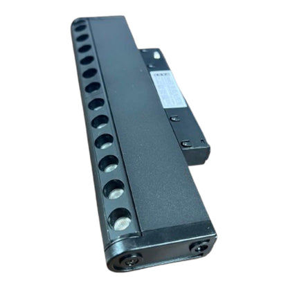 A black metal multi-port power supply or connector module with multiple circular ports on one side and a small white label, shown on a plain white background.