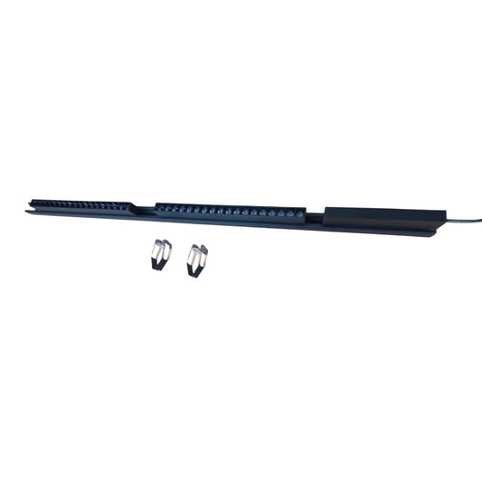 A long black electronic strip device with multiple small blue indicator lights, shown horizontally on a plain white background, with two small metal clips below it.