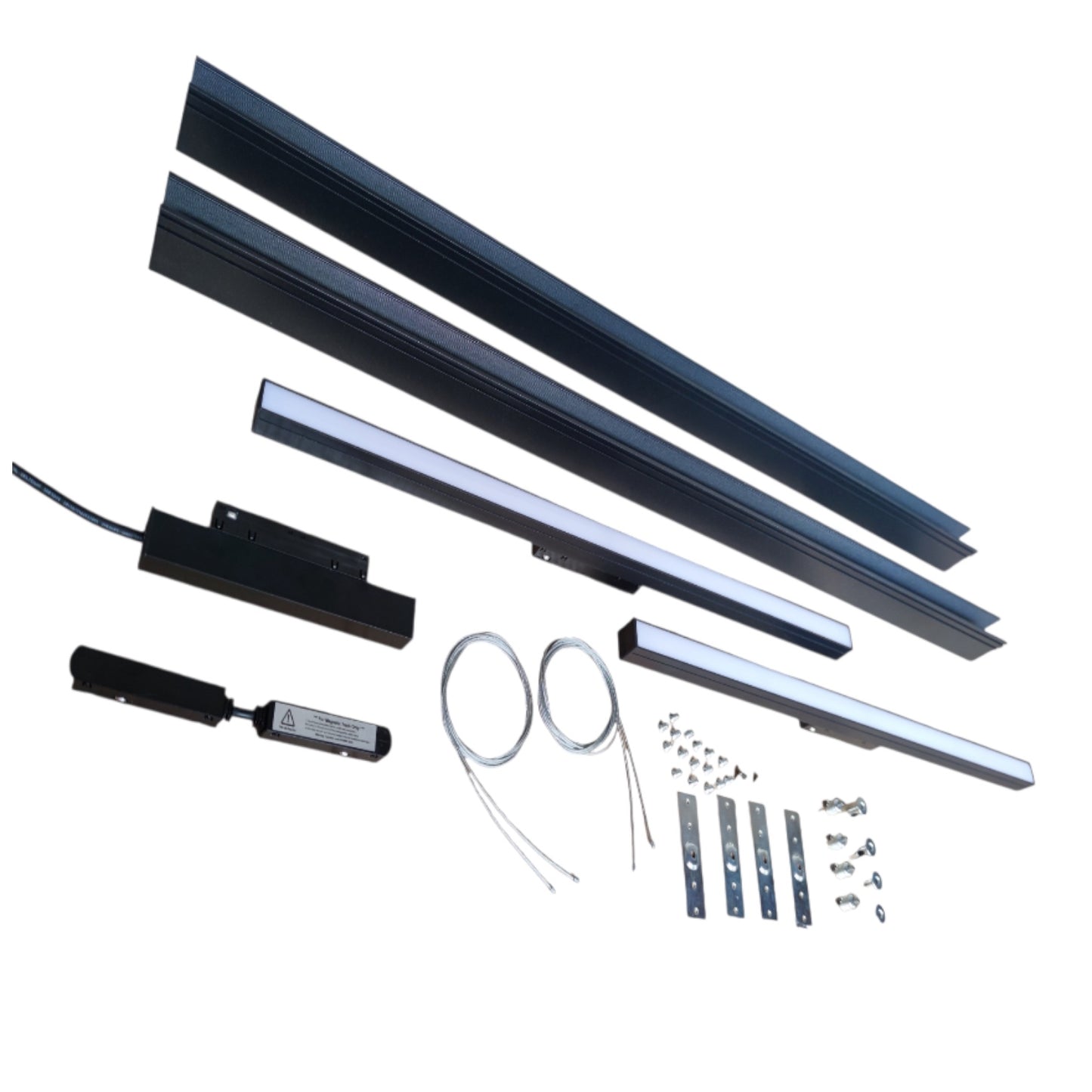A linear LED light bar kit with multiple black aluminum channel rails, a black electronic driver module, a small black control box, two coiled wire leads, mounting brackets, and small hardware pieces, all arranged on a plain white background.