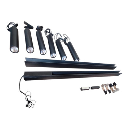 A set of black outdoor landscape lights and mounting accessories, including six adjustable cylindrical spotlights, two long linear light bars, a power cord, and three ground stakes, displayed on a solid white background.