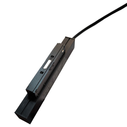 Black electronic device with a cable on a white background