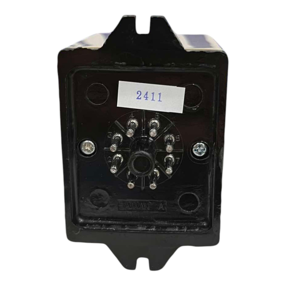 A black electrical contactor or relay module with a circular multi-terminal connector on the front face, secured with screws, featuring a white label with the number 2411.