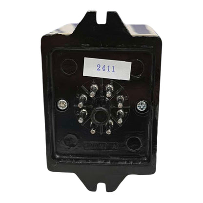 A black electrical contactor or relay module with a circular multi-terminal connector on the front face, secured with screws, featuring a white label with the number 2411.