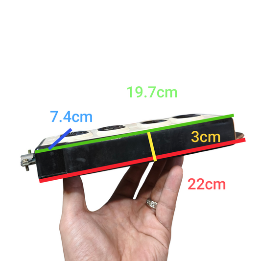 Hand holding a small model train with measurements labeled on a white background