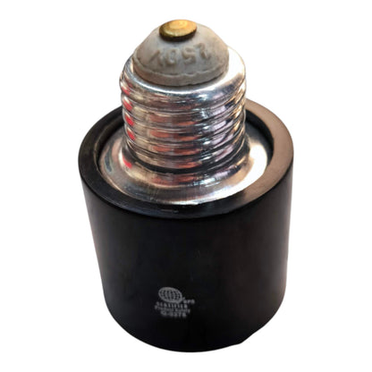 A black cylindrical lamp holder or socket with a silver metal screw base and a small brass-colored top, shown on a plain white background.