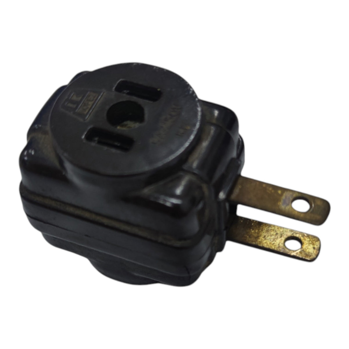 A black plastic electrical outlet adapter with two brass-colored metal prongs, shown on a plain white background.