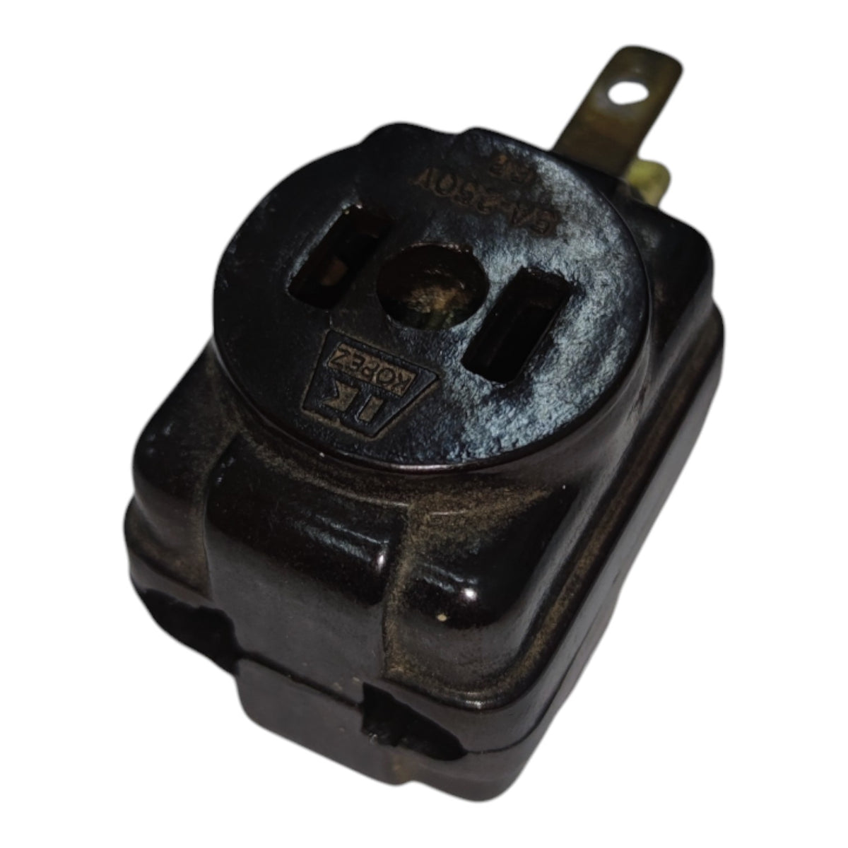 A black molded electrical outlet component with a single brass-colored terminal, photographed on a plain white background.