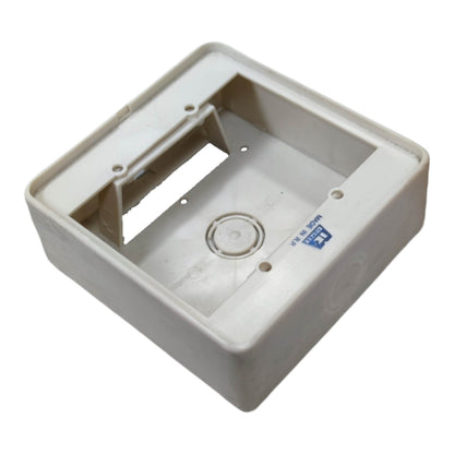 A square off-white plastic electrical junction box or socket housing, shown at an angle on a plain white background.