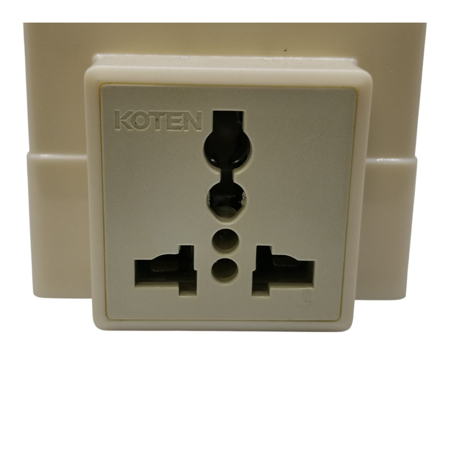 A cream-colored plastic Koten brand UK three-pin wall outlet plug adapter, shown against a plain white background.