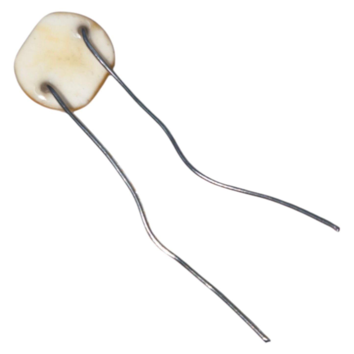 Hairpin with a round, beige ceramic bead on a white background